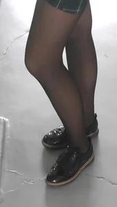 Closeups of Skinny Legs of a College Girl in a Skirt And Black Pantyhose
