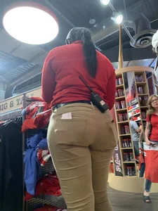 Bunch of girls in various outfits at a Cardinals baseball game