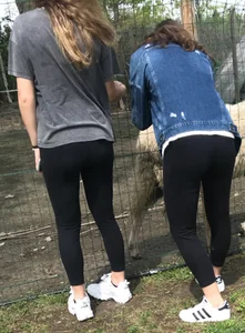 Two candid teens in leggings at the zoo