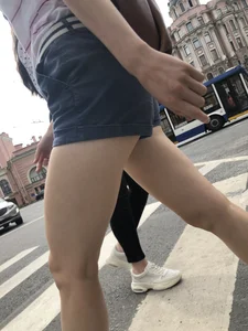 Young Girl in Shorts And Sandals Crossing the Street Gallery