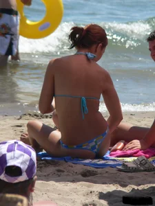 A bunch of hot babes on the beach in thong bikinis