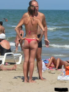 A bunch of hot babes on the beach in thong bikinis