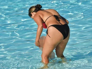 Sexy milf with a nice mom bod in a bikini in the pool