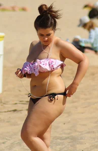 Thick girl on the beach with big boobs and a big booty