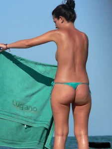 Bunch of sexy babes on the beach topless and in thong bikinis