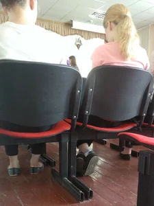 Cute College Teen Sitting With Crossed Feet