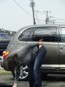 Girl cleaning her car in jeans and showing some cheetah print underwear