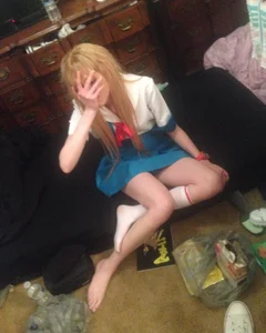 Teen in School Uniform Sitting on the Floor in a Skirt and One Knee-Sock