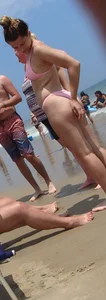 Sexy girl on the beach in a pink bikini