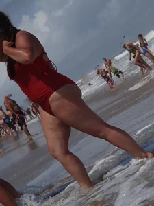 Fat chick on the beach in a red swimsuit