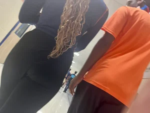 College teen wearing tight pants walking down the hall