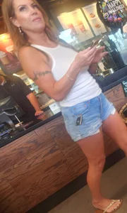Short shorts on hot milf buying coffee