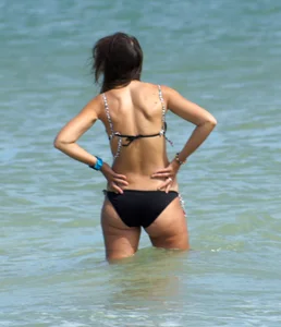 Older mature beach lady in a black bikini