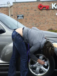 Girl cleaning her car in jeans and showing some cheetah print underwear
