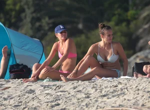 Two sexy friends out on the beach in bikinis