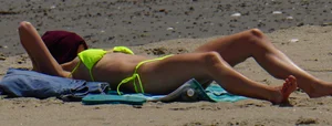 Sexy ass blonde milf on the beach in a thong with cameltoe and bending over