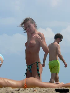Two topless friends on the beach with nice boobs
