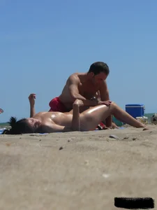 Purple thong topless lady on the beach gets oiled up by her husband