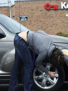 Girl cleaning her car in jeans and showing some cheetah print underwear