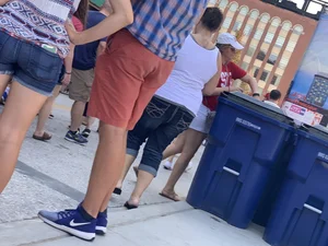 Bunch of girls in various outfits at a Cardinals baseball game