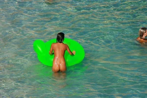 FKK Nudists playing in the water with floater