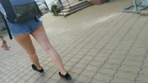 Girl walking in denim shorts showing some of her ass cheeks