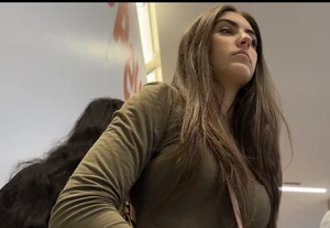 Latina shaking her ass in line
