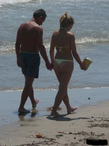 Sexy blonde on the beach in a yellow thong bikini