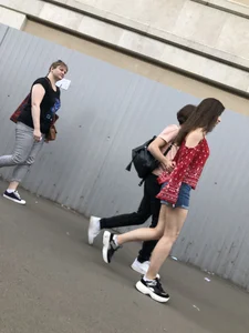 Very hot candid girl in denim shorts walking down the train platform