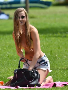 Sexy blonde girl in the park playing volleyball in her skimpy bikini
