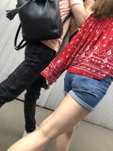 Very hot candid girl in denim shorts walking down the train platform