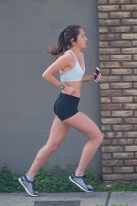 Beautiful girl out for a run in spandex shorts