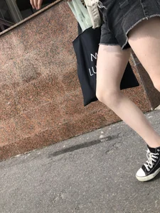 Cute candid teen with pale slim legs in shorts