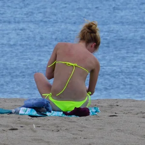 Sexy ass blonde milf on the beach in a thong with cameltoe and bending over