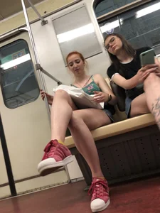 Two Girls With Hot Long Legs in Mini Shorts and Sneakers in the Subway Train Candid Photo Gallery