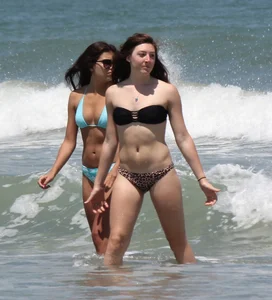 Brunette and redhead on the beach in bikinis looking sexy