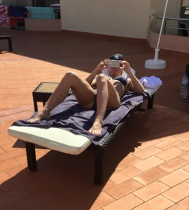 Blonde laying out in a blue bikini with a sexy body