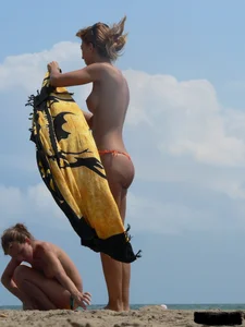 Two topless friends on the beach with nice boobs