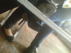Legs of Young College Students Under Desk Photos