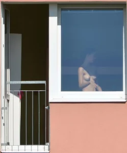 Peeping Tom pics of a topless girl in her house with nice tits