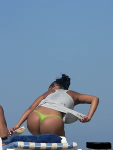 Hot ass topless beach girl with great tits lets her little brother oil up her ass in thong bikini