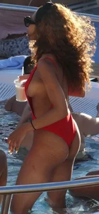 Sexy black girl in red swimsuit at the pool with side boob and a nice ass