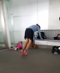 Skinny Girl in a Skirt and Pink Sneakers Doing Pushups
