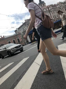 Young Girl in Shorts And Sandals Crossing the Street Gallery