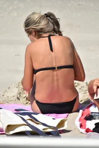 Blonde and brunette on the beach looking sexy in their bikinis