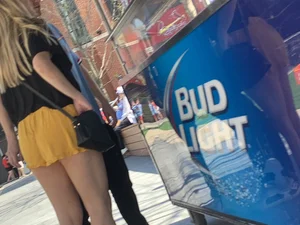 Bunch of girls in various outfits at a Cardinals baseball game