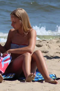 Beautiful skinny blonde babe with cute ass in bikini on the beach