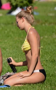 Sexy blonde girl in the park playing volleyball in her skimpy bikini