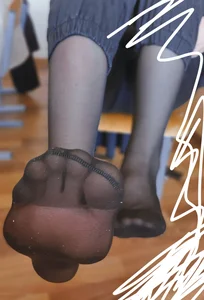Closeup of a College Teen's Feet in Black Pantyhose in Class