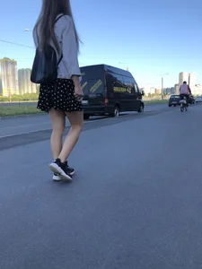 Extremely Cute Girl in a Skirt With a Backpack Passing By on the Street Gallery